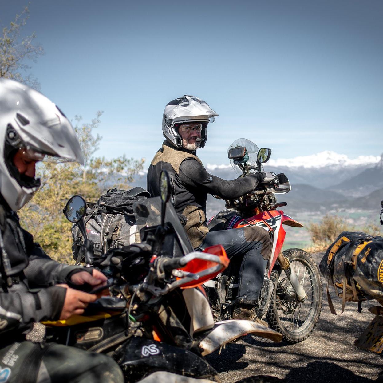 adventure rider wearing supershirt on red honda motorbike at the top of a mountain in Spain